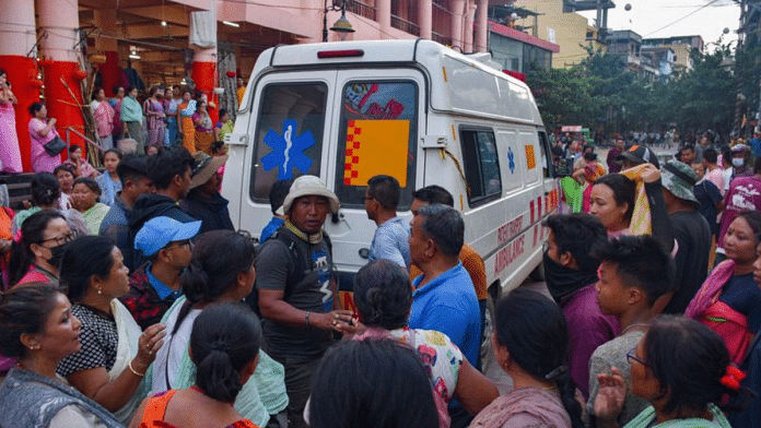 People gather around an ambulance carrying a body of a man killed in a violence between ethnic groups in northeastern state of Manipur, India | REUTERS/Stringer/File Photo