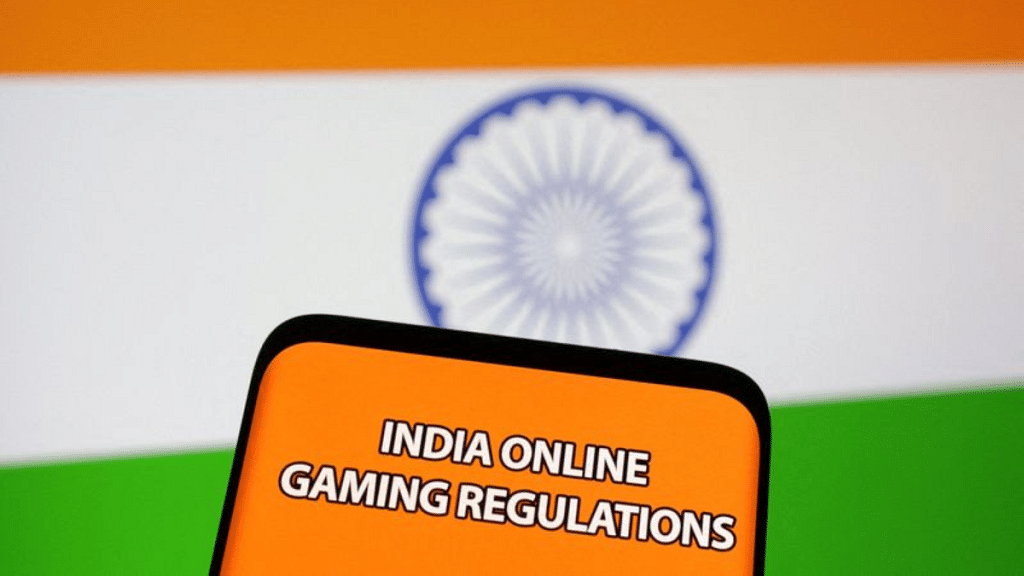 The words "India online gaming regulations" are displayed in front of an Indian flag | Illustration by Dado Ruvic/Reuters
