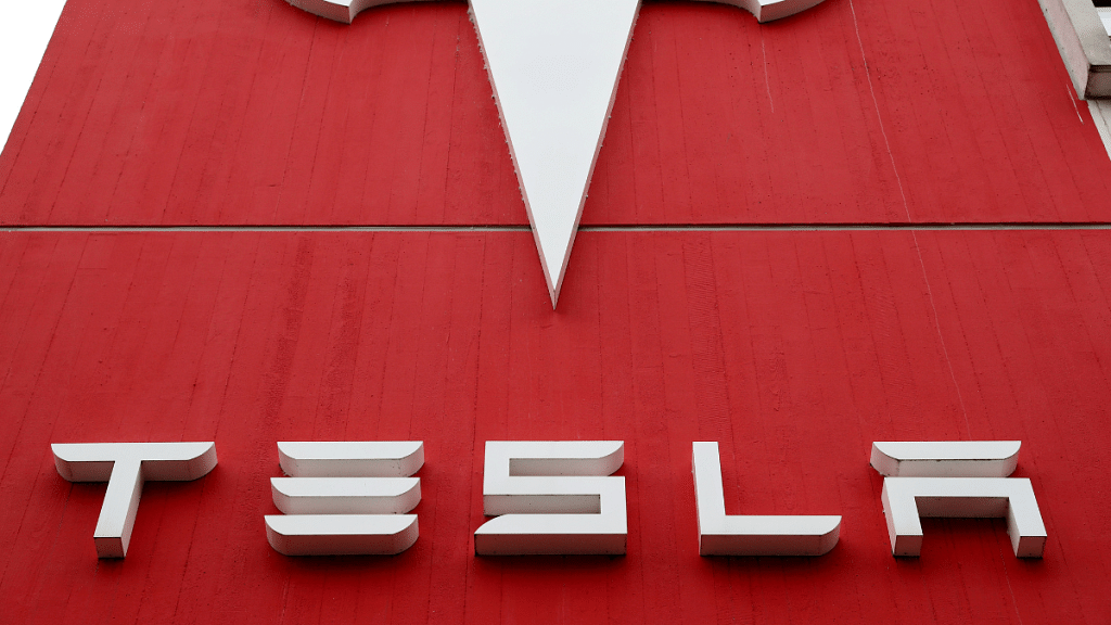 The logo of car manufacturer Tesla is seen at a branch office in Bern, Switzerland | Reuters