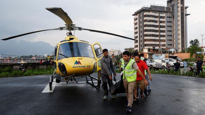 People carry the body of a person killed in a helicopter crash belonging to Manang air, at Tribhuvan University Teaching Hospital in Kathmandu, Nepal July 11, 2023 | Reuters