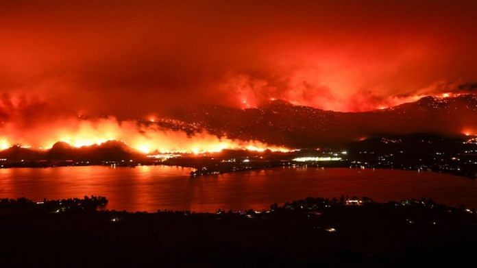 A long exposure image shows the Eagle Bluffs Wildfire, which crossed the border from the U.S. state of Washington, and prompted evacuation orders in Osoyoos, British Columbia, Canada July 30, 2023 | Reuters
