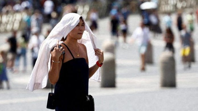 A woman walks during a heatwave across Italy, in Vatican City, on July 19, 2023 | Reuters/Remo Casilli