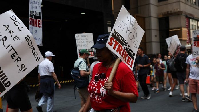 Striking Writers Guild of America (WGA) members walk the picket line in New York City | Reuters