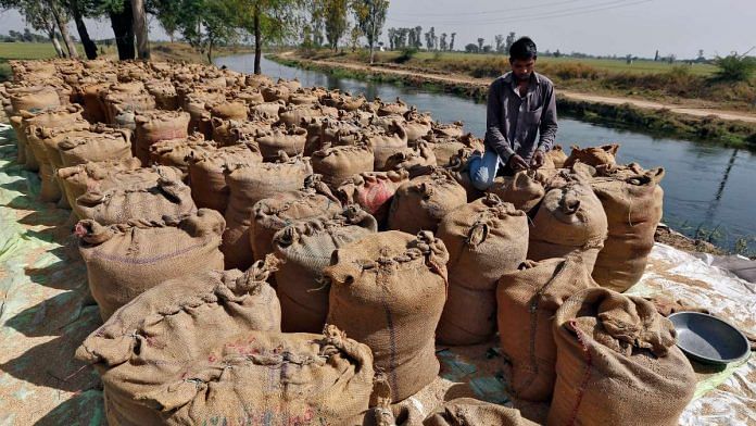 A worker packs a sack filled with rice on the outskirts of the western city of Ahmedabad | Reuters file photo