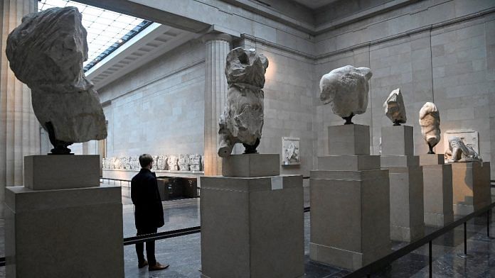 An employee poses as he views examples of the Parthenon sculptures on display at the British Museum in London | Reuters file photo