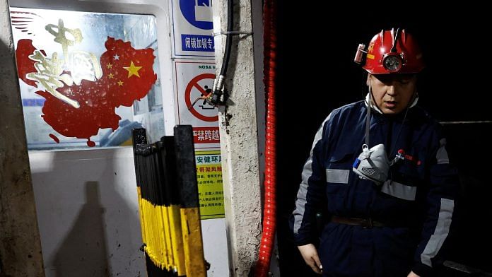 A man walks near a sticker in the shape of China's map | Representational image | Reuters