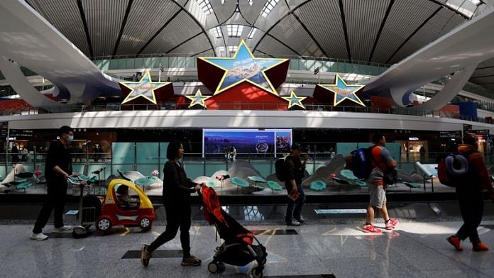 Travellers walk past an installation in the shape of five stars, at Beijing Daxing International Airport in Beijing, China April 24, 2023 | Reuters