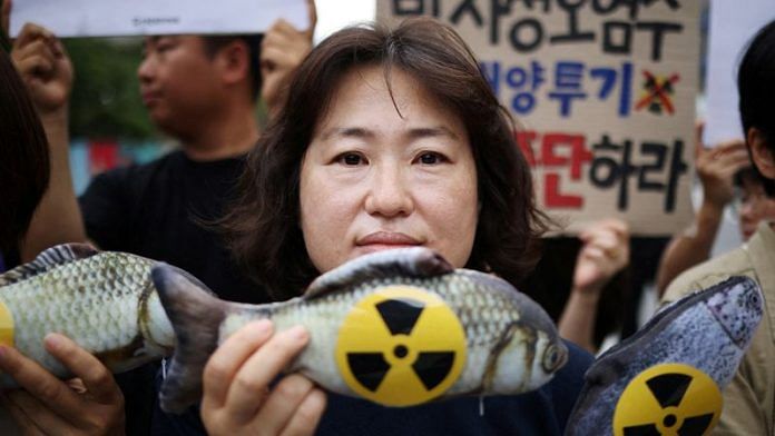 An activist poses for a photograph during a protest against Japan's plan to release treated wastewater from the Fukushima nuclear power plant into the ocean, at the national assembly in Seoul, South Korea, August 24, 2023 | Reuters