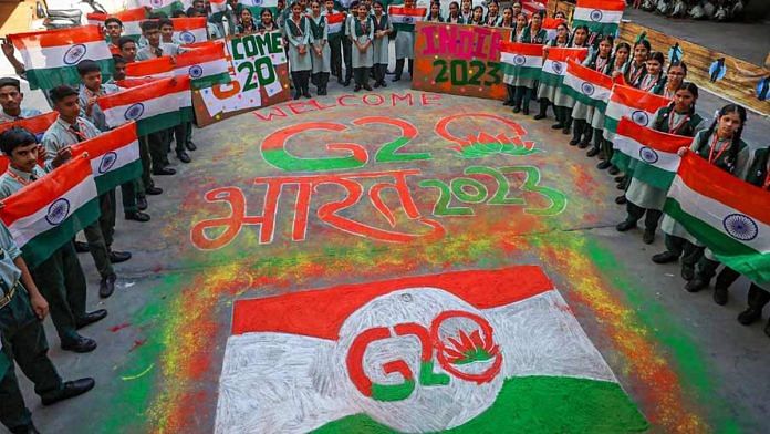 Students make a 'rangoli' of the G20 logo in Srinagar | Photo: PTI