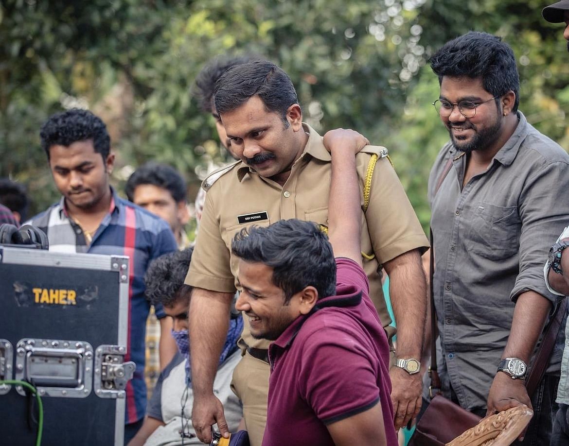 Basil (seated) with Aju Varghese during the shoot of Minnal Murali | Instagram