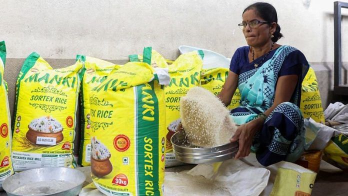 A woman cleans rice grains at a wholesale market in Navi Mumbai | Reuters file photo