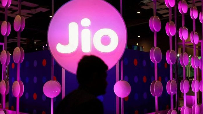 A man walks across the LED board showing the logo of Jio at the ongoing India Mobile Congress 2022, at Pragati Maidan, in New Delhi | Reuters