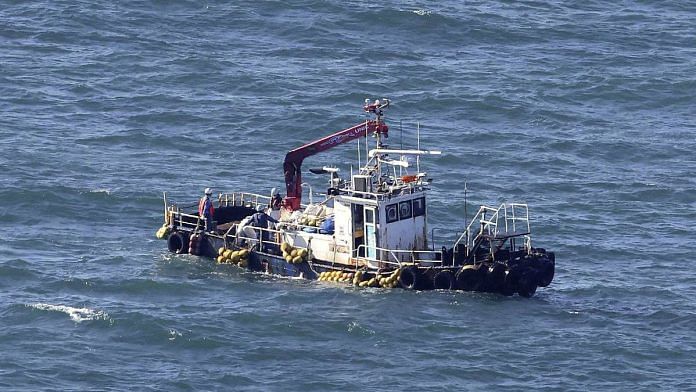 A boat collecting seawater for monitoring radioactive materials in the sea is seen near the Fukushima Daiichi Nuclear Power Plant, on 24 August 2023 | Kyodo/via Reuters