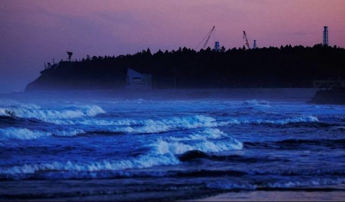 Ventilation stacks and cranes at the disabled Fukushima Dai-ichi nuclear power plant are seen from a beach in Namie, about 7 km away from the power plant, in Fukushima Prefecture, Japan | Reuters