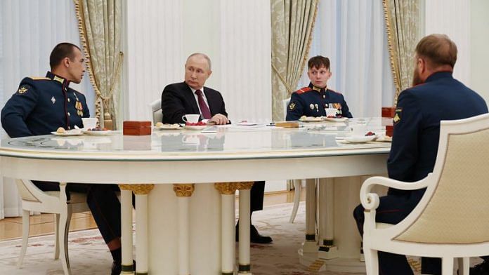 Russian President Vladimir Putin meets with the crew of the Alyosha T-80 tank, which destroyed a Ukrainian armoured convoy on the Zaporizhzhia direction in the course of Russia-Ukraine conflict, at the Kremlin in Moscow | Reuters
