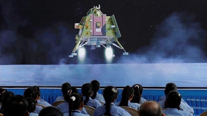 People watch a live stream of Chandrayaan-3 spacecraft's landing on the moon, inside an auditorium of Gujarat Science City in Ahmedabad | Reuters