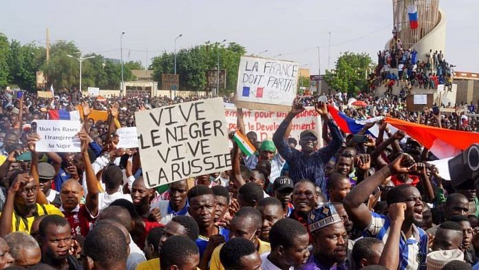 Demonstrators gather in support of soldiers in Niger capital Niamey on 30 July, holding signs reading ‘Long live Niger, long live Russia’, ‘France must leave’ | Photo: Reuters
