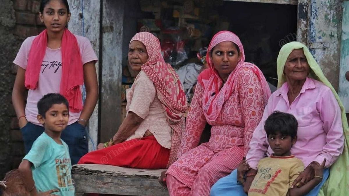 Families sit outside, on a Nuh street, Wednesday | Praveen Jain | ThePrint