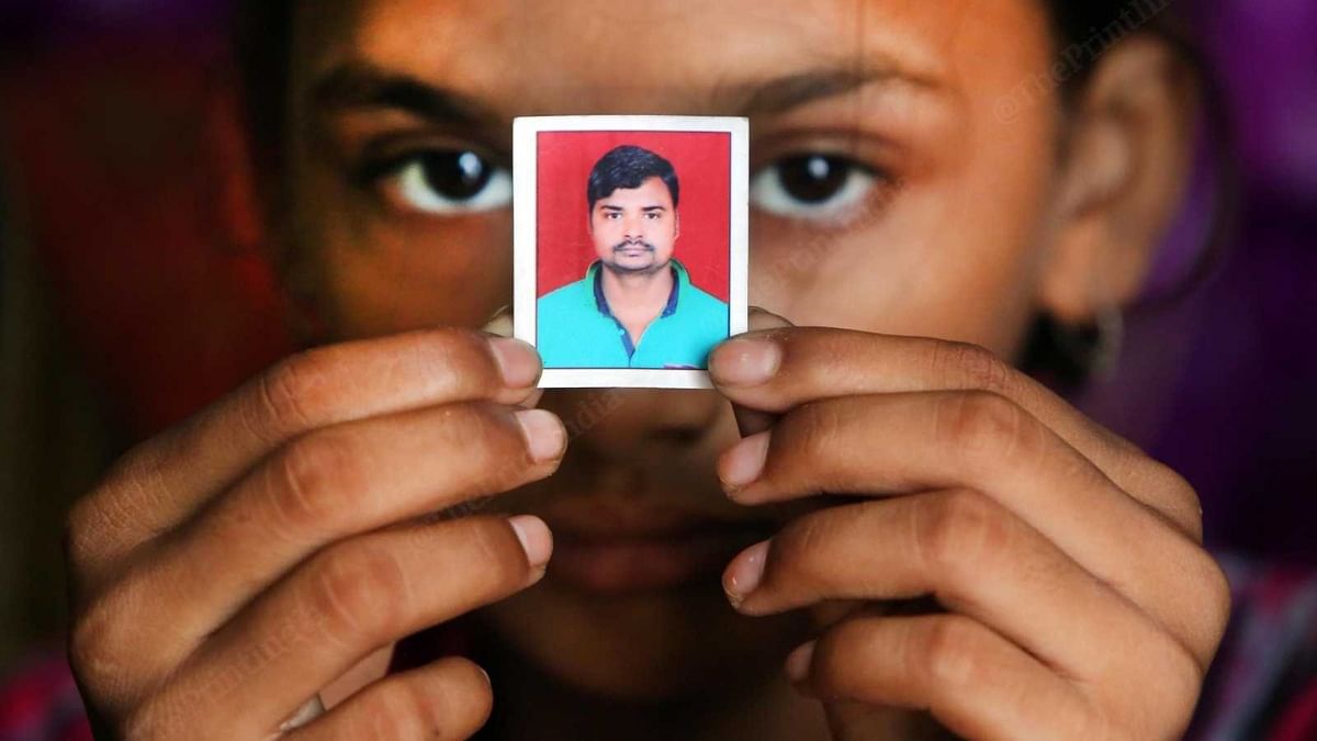 Mehak, with a photo of her father Shakti Singh who was killed in Nuh violence| Praveen Jain | ThePrint