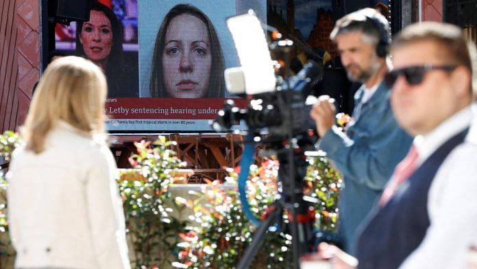Members of the media work near a large screen showing a picture of convicted hospital nurse Lucy Letby, ahead of her sentencing, outside the Manchester Crown Court in Britain | Reuters/Phil Noble