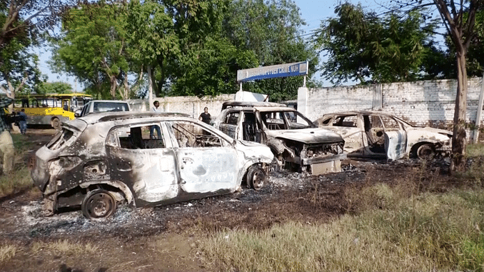 Burnt vehicles lie on the road in the aftermath of communal clashes in Haryana's Nuh | ANI