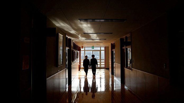 Eita Sato, 15, and Aoi Hoshi, 15, walk along the corridors of Yumoto Junior High School, where they are the only two students, in Fukushima Prefecture, Japan | Reuters/Issei Kato/file photo