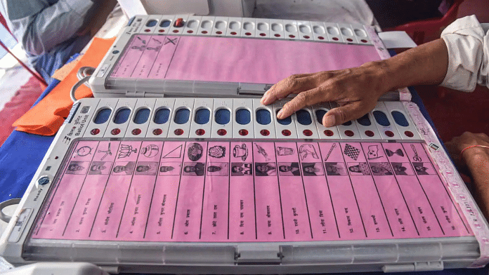 File photo of an EVM with list of candidates being checked by a poll official | PTI