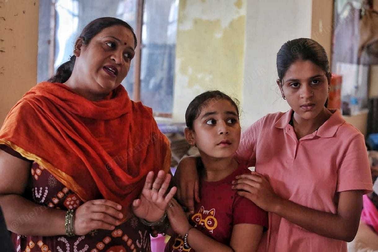 Lata Ghai and her daughters, who lost their home in the 15 August landslide, at Ambedkar Bhawan | Praveen Jain | ThePrint