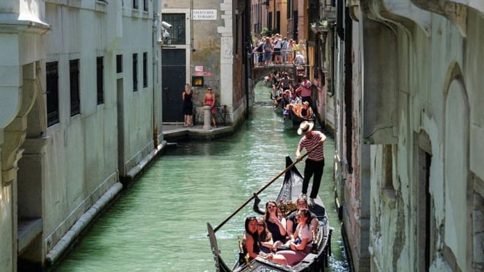 Gondoliers row their gondolas through the Venice Canal as the city prepares for the Redentore Festival celebrations in Venice | Reuters file photo