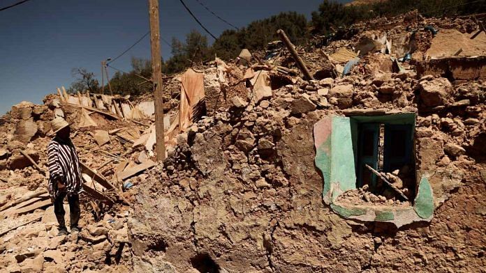 Mohamed Ouchen, 66, a survivor, who helped to pull his sister and her husband with their children from rubble, looks at his destroyed house, in the aftermath of a deadly earthquake, in Tikekhte, near Adassil, Morocco | Reuters