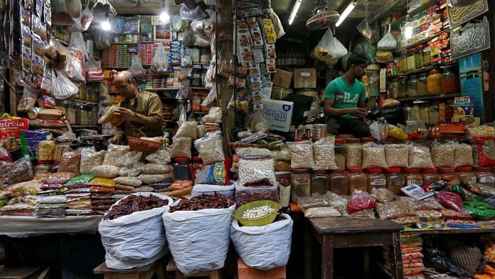 A vendor sells vegetables at a retail market in Kolkata, India | Reuters