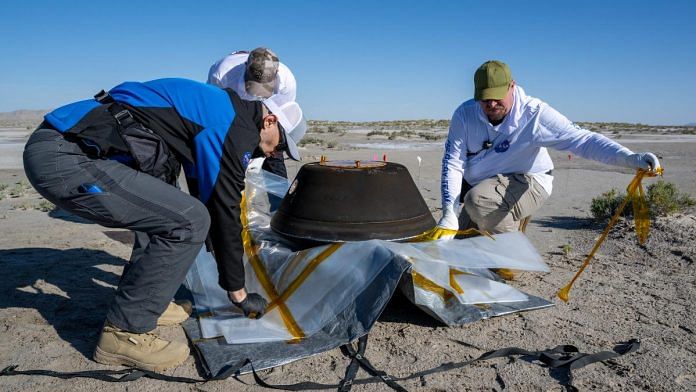 The return capsule containing a sample collected from the asteroid Bennu in October 2020 by NASA’s OSIRIS-REx spacecraft is seen shortly after touching down in the desert at the Department of Defense's Utah Test and Training Range in Dugway, Utah, U.S. September 24, 2023. NASA/Keegan Barber/Handout via REUTERS