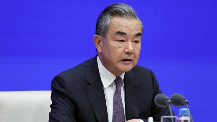 Chinese Foreign Minister Wang Yi attends a press conference on the white paper on 