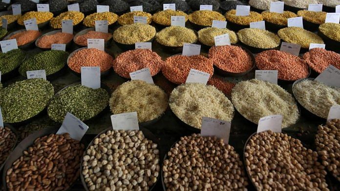 Price tags are seen on the samples of rice and lentils that are kept on display for sale at a wholesale market in the old quarters of Delhi, India | Reuters File Photo