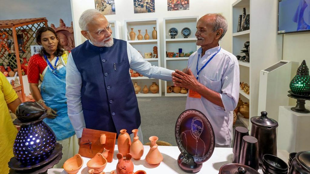 Prime Minister Narendra Modi meets a craftsman during an exhibition at the inauguration of the first phase of India International Convention and Expo Centre (IICC), named YashoBhoomi, at Dwarka, in New Delhi on Sunday | ANI