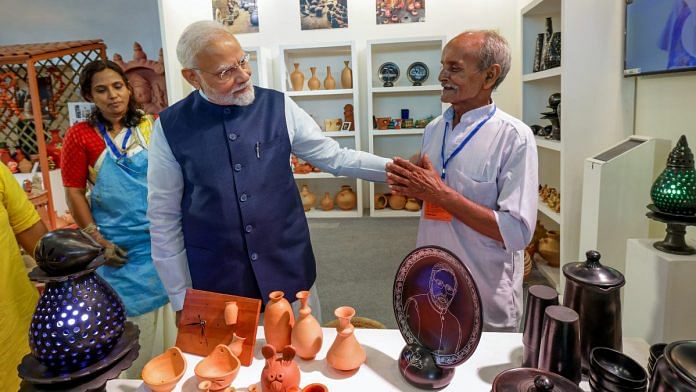 Prime Minister Narendra Modi meets a craftsman during an exhibition at the inauguration of the first phase of India International Convention and Expo Centre (IICC), named YashoBhoomi, at Dwarka, in New Delhi on Sunday | ANI