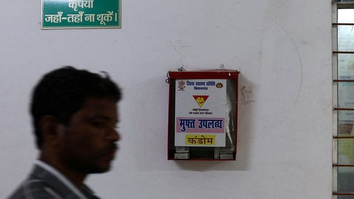 A man walks past a free condom dispenser at a community health centre in Bahadurganj subdivision of Kishanganj district, Bihar | Reuters