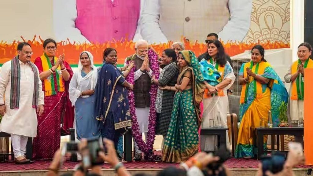 Women workers felicitate PM Narendra Modi during the ‘Nari Shakti Vandan-Abhinandan Karyakram’ at the BJP headquarters. Union minister Smriti Irani and BJP president J.P. Nadda were also present | Photo: PTI