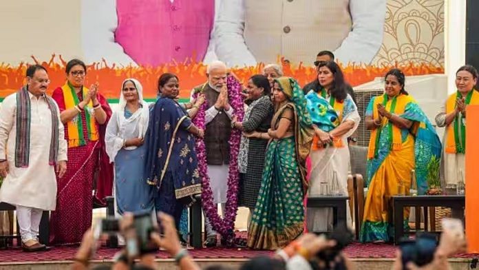 Women workers felicitate PM Narendra Modi during the ‘Nari Shakti Vandan-Abhinandan Karyakram’ at the BJP headquarters. Union minister Smriti Irani and BJP president J.P. Nadda were also present | Photo: PTI