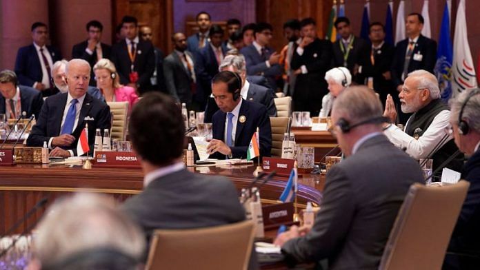 PM Narendra Modi speaks as US President Joe Biden with other leaders listens during the first session of the G20 Summit, in New Delhi, on 9 September 2023 | Evan Vucci/Pool via Reuters