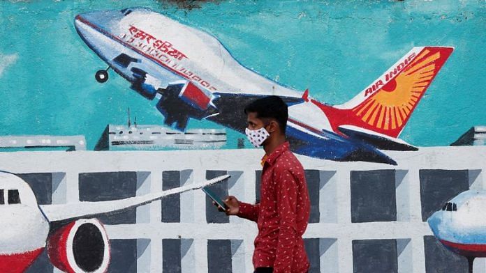 A man walks past a mural of Air India airlines on a street in Mumbai | Reuters