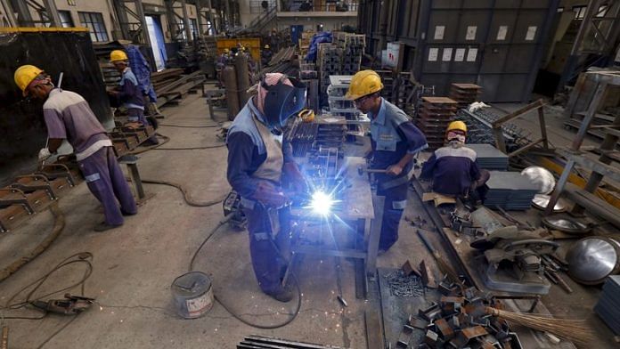 Employees make iron parts which are used to construct bridges inside a manufacturing unit in an industrial area on the outskirts of Kolkata | Reuters file photo