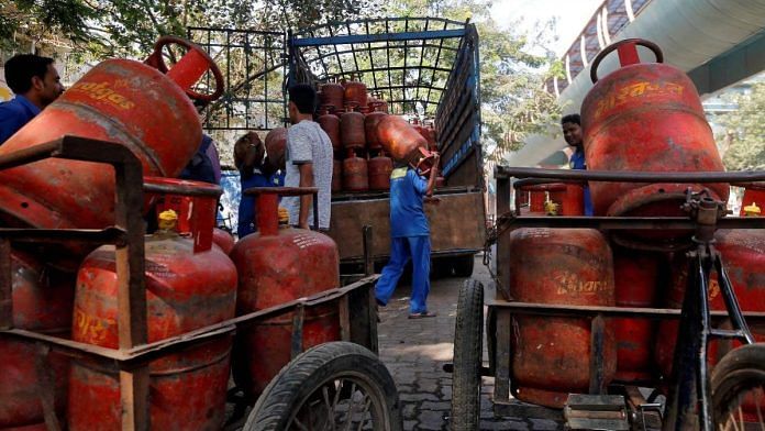 Workers load liquefied petroleum gas (LPG) cooking cylinders onto a supply truck outside a distribution centre in Mumbai | Reuters file photo