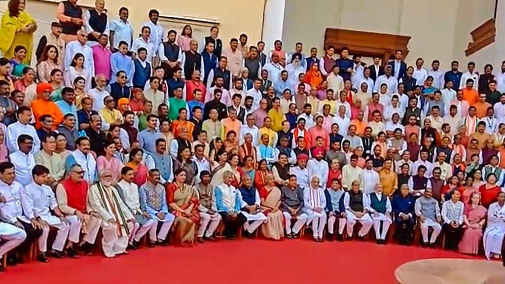 Lok Sabha and Rajya Sabha members pose for a group photograph at the old Parliament House complex during a special session, on 19 September 2023 | PTI