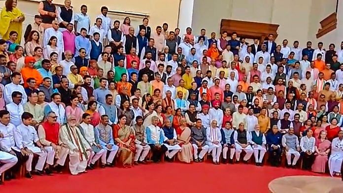 Lok Sabha and Rajya Sabha members pose for a group photograph at the old Parliament House complex during a special session, on 19 September 2023 | PTI