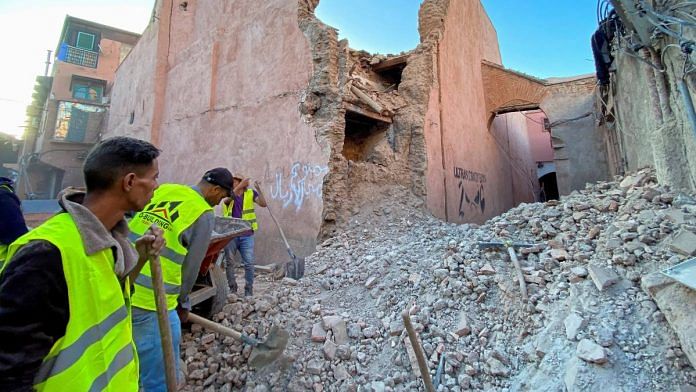 People work next to damage in the historic city of Marrakech, following a powerful earthquake in Morocco, on 9 September 2023 | Reuters