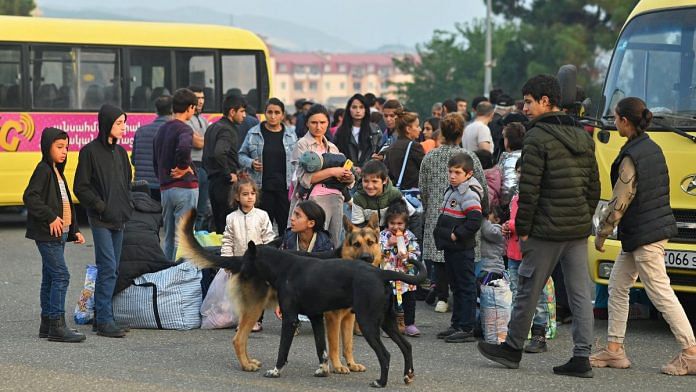 Residents gather next to buses in central Stepanakert before leaving Nagorno-Karabakh, a region inhabited by ethnic Armenians, on 25 September 2023 | Reuters/David Ghahramanyan