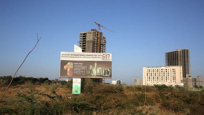 A billboard stands in front of buildings under construction at the Gujarat International Finance Tec-City (GIFT) at Gandhinagar, in the western state of Gujarat | Reuters
