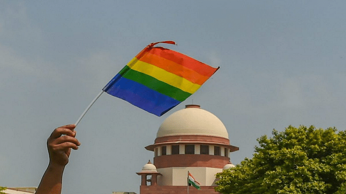 File photo of an activist waving a pride flag in front of the Supreme Court in New Delhi | PTI