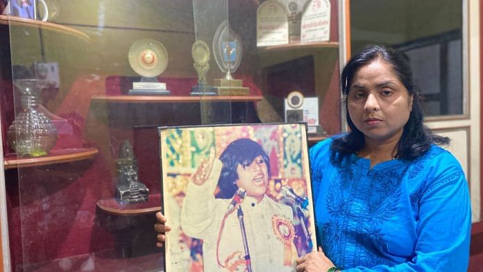 Nidhi Shukla with her sister Madhumita’s photograph at their house in Lakhimpur Kheri's Mishrana | Shikha Salaria, ThePrint